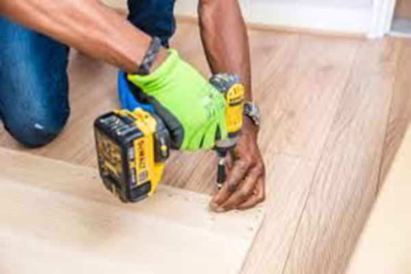 Tradesman Installing A Floor - Carpentry - Australian Building Maintenance Company